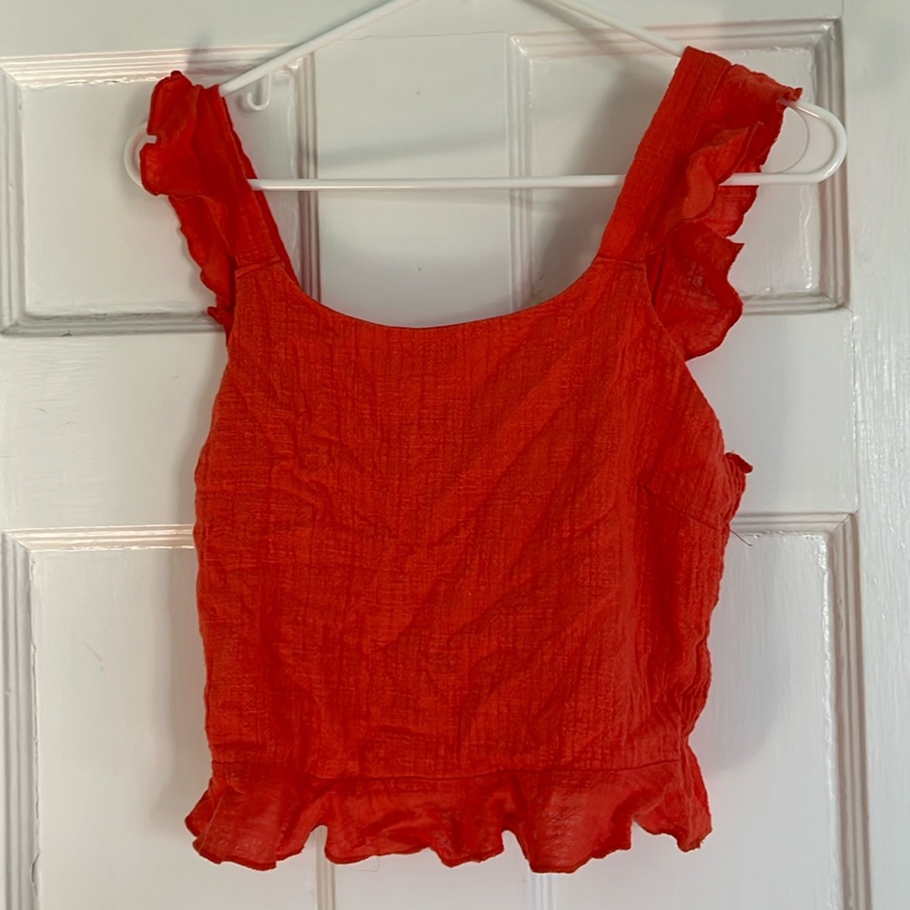 Coral linen crop top with a smocked back and ruffle straps.